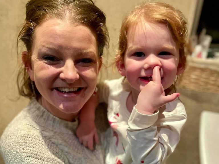 A photograph of me and my daughter, sat on the loo, she's picking he nose. We are both smiling. 